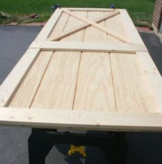a large wooden table sitting on top of a sidewalk