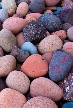 many different colored rocks on the ground
