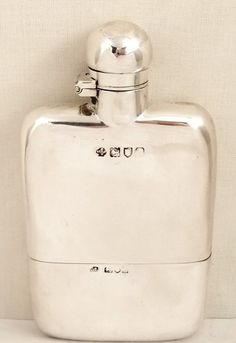 a silver flask shaped like an ice chest
