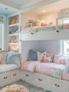 a bedroom with bunk beds and pillows in it