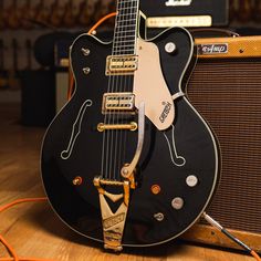 an electric guitar sitting on top of a wooden floor
