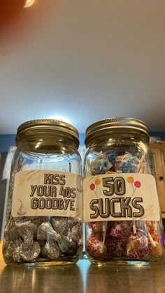 two jars filled with candy sitting on top of a counter