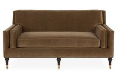 a brown couch sitting on top of a white floor