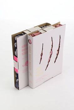 an opened box containing several different items on a white surface with pink and blue accents