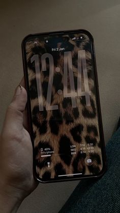a person holding an iphone in their hand with the number 1244 displayed on it