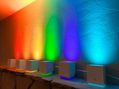 there are several different colored lights on the wall next to each other in this room