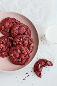 chocolate chip cookies on a plate next to a glass of milk