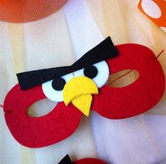 a close up of a red mask with an angry bird on it