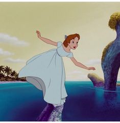 the little mermaid is standing in the water