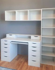 a white desk with drawers and shelves in a room