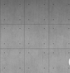 an apple logo on the side of a concrete wall with dots in black and white