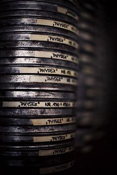 many black and white labels are stacked on top of each other in the dark room