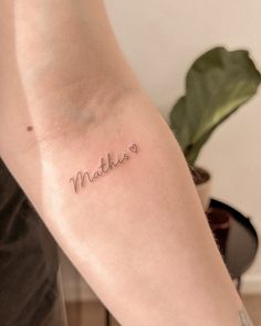 a woman's arm with the word mother written in cursive font on it