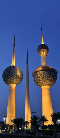 two tall towers are lit up at night