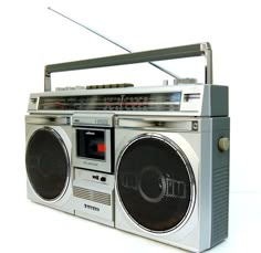 an old fashioned radio with two speakers on it's sides and a boom box attached to the front