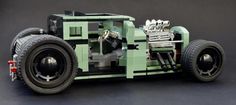 a toy car made out of legos sitting on a table next to a black background