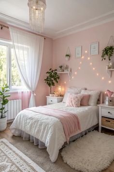 a bedroom decorated in pink and white with lights on the wall above the bed, along with a rug
