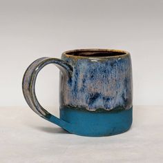 a blue and brown mug sitting on top of a table
