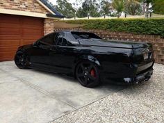 a black sports car parked in front of a house