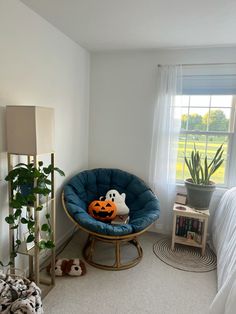 a bedroom with a chair, bed and plants in it