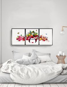 three paintings on the wall above a bed
