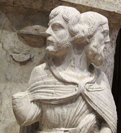 a statue of a man holding a bird in his hand