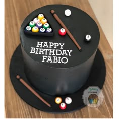 a black birthday cake with pool balls and cues on the top, happy birthday fabio