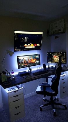 two computer monitors sitting next to each other on top of a desk in a room