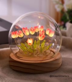 there is a glass ball with flowers in it