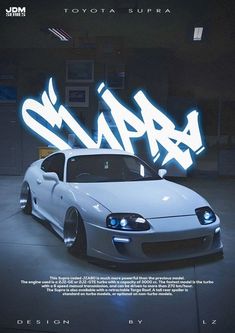 a white sports car parked in front of a building with graffiti on it's side