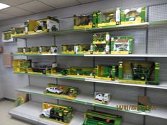 there are many toy trucks on the shelves