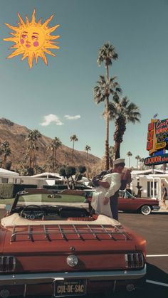 a man standing next to a red car in a parking lot with palm trees and signs