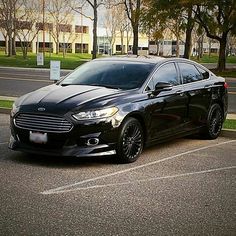 a black car parked in a parking lot