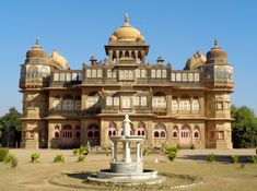 an old building with a fountain in front of it