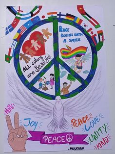 a peace sign painted on the side of a wall with children's drawings around it