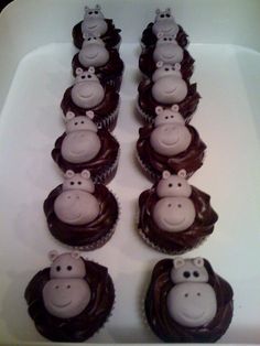there are many cupcakes with chocolate frosting in the shape of monkeys