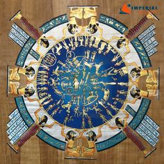 a wooden table topped with a large blue and gold clock on top of it's side