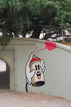 a black and white photo of a spray can painted on the side of a wall