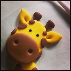 a cake shaped like a giraffe on top of paper