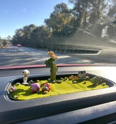 a car dashboard filled with fake plants and animals
