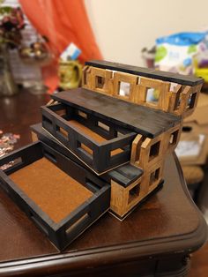 three pieces of wood sitting on top of a wooden table next to each other,