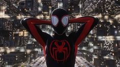 a spider man standing in front of a cityscape with his back to the camera