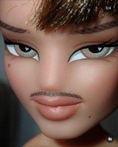 a close up of a doll's face with fake hair