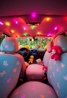 the interior of a car with colorful lights and stuffed animals on the front row seat