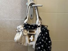 two purses hanging on the wall next to each other