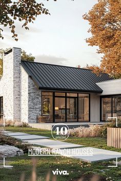 the modern ranch house is surrounded by grass and trees