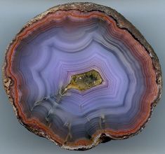 an agate stone with yellow and purple stripes