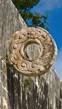 a stone wall with a circular decoration on it