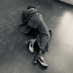 a person laying on the floor with their head down