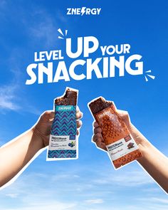 two hands holding up some snacks in front of a blue sky with the words level up your snacking